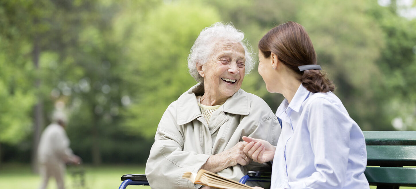 senior-woman-with-caregiver-in-the-park